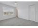 Bright bedroom with grey carpeting and large window at 6111 Fairmont Ln, Palmetto, FL 34221