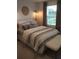 Comfortable bedroom with a queen-size bed and window at 6111 Fairmont Ln, Palmetto, FL 34221