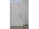 White interior door, light gray tile, and carpeted stairs at 6111 Fairmont Ln, Palmetto, FL 34221