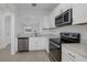 Modern kitchen featuring stainless steel appliances and white cabinetry at 6111 Fairmont Ln, Palmetto, FL 34221