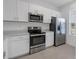 Modern kitchen with stainless steel appliances and white cabinets at 6111 Fairmont Ln, Palmetto, FL 34221