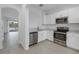Modern kitchen with white cabinets and stainless steel appliances at 6111 Fairmont Ln, Palmetto, FL 34221