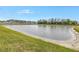Scenic view of a tranquil lake with lush green grass at 6111 Fairmont Ln, Palmetto, FL 34221