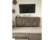 Modern TV stand with ample storage in living room at 6111 Fairmont Ln, Palmetto, FL 34221