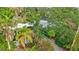 Mid-century modern home nestled amongst tropical foliage at 6231 Beechwood Ave, Sarasota, FL 34231