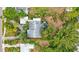 Single-story home with a pool, screened enclosure, and lush landscaping at 6231 Beechwood Ave, Sarasota, FL 34231