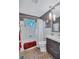 Modern bathroom with white tile, tub, and updated vanity at 6231 Beechwood Ave, Sarasota, FL 34231