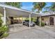 Covered carport parking with lush tropical landscaping at 6231 Beechwood Ave, Sarasota, FL 34231