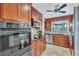 Updated kitchen with stainless steel appliances and wood cabinets at 6231 Beechwood Ave, Sarasota, FL 34231