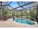 Inviting kidney-shaped pool with screened enclosure and patio furniture at 6231 Beechwood Ave, Sarasota, FL 34231