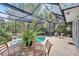 Charming screened pool area with patio furniture and lush landscaping at 6231 Beechwood Ave, Sarasota, FL 34231