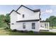 White two-story house with black roof and windows, showcasing side yard at 639 Oakford Rd, Sarasota, FL 34240