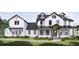Two-story farmhouse with white siding, black accents, and a large front porch at 639 Oakford Rd, Sarasota, FL 34240
