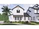 Two-story farmhouse with white siding, black accents, and a large front porch at 639 Oakford Rd, Sarasota, FL 34240