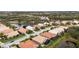 Aerial view of a residential neighborhood with houses and a lake at 6411 41St E Ct, Sarasota, FL 34243