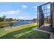 Backyard view showing screened porch and lake view at 6411 41St E Ct, Sarasota, FL 34243