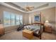 Spacious bedroom with a king-size bed, exercise equipment, and water views at 6411 41St E Ct, Sarasota, FL 34243