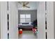 Small bedroom with twin bed, window with shutters, and ceiling fan at 6411 41St E Ct, Sarasota, FL 34243