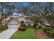 Single-story home with tile roof, attached garage, and landscaped yard at 6726 Virginia Xing, University Park, FL 34201