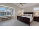 Spacious bedroom with large window and dark wood furniture at 6726 Virginia Xing, University Park, FL 34201