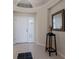 Bright entryway with white door, plantation shutters, and tile floor at 6726 Virginia Xing, University Park, FL 34201