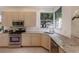 Well-equipped kitchen featuring stainless steel appliances and corner sink at 6726 Virginia Xing, University Park, FL 34201