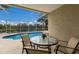 Relaxing pool area with patio furniture and lake view at 6726 Virginia Xing, University Park, FL 34201