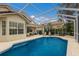 Screened pool with lake view and patio furniture at 6726 Virginia Xing, University Park, FL 34201