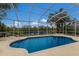 Refreshing screened pool overlooking a lake at 6726 Virginia Xing, University Park, FL 34201
