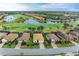 Aerial view of community with houses, landscaping, and waterways at 6933 Quiet Creek Dr, Bradenton, FL 34212