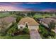 Aerial view of single-Gathering home with tile roof, golf course views at 6933 Quiet Creek Dr, Bradenton, FL 34212