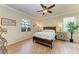 Bright bedroom with wood-look floors and a ceiling fan at 6933 Quiet Creek Dr, Bradenton, FL 34212