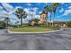 Elegant community center with palm trees and circular driveway at 6933 Quiet Creek Dr, Bradenton, FL 34212