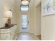 Bright foyer with decorative console table and stained glass door at 6933 Quiet Creek Dr, Bradenton, FL 34212