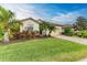 Landscaped front yard with lush greenery and palm trees at 6933 Quiet Creek Dr, Bradenton, FL 34212