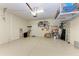 Two-car garage with overhead storage and extra shelving at 6933 Quiet Creek Dr, Bradenton, FL 34212