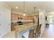 Modern kitchen with granite countertops, stainless steel appliances, and an island with seating at 6933 Quiet Creek Dr, Bradenton, FL 34212