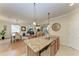 Kitchen with granite island, stainless steel appliances, and view of dining area at 6933 Quiet Creek Dr, Bradenton, FL 34212