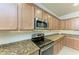 Modern kitchen with stainless steel appliances and granite countertops at 6933 Quiet Creek Dr, Bradenton, FL 34212