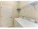 Laundry room with washer, dryer, and ample shelving at 6933 Quiet Creek Dr, Bradenton, FL 34212