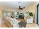 Spacious living room featuring light beige sofas and wood-look floors at 6933 Quiet Creek Dr, Bradenton, FL 34212