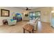 Spacious living room with hardwood floors, recessed lighting and sliding doors to patio at 6933 Quiet Creek Dr, Bradenton, FL 34212