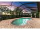 Relaxing kidney-shaped pool with covered patio at 6933 Quiet Creek Dr, Bradenton, FL 34212