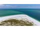 Aerial of beachfront property showing white sand beach and ocean at 727 Holly Rd, Anna Maria, FL 34216