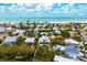 Aerial perspective of a modern two-story house by the water, featuring a private pool at 727 Holly Rd, Anna Maria, FL 34216