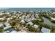 Aerial view of a charming house near the water, surrounded by lush greenery at 727 Holly Rd, Anna Maria, FL 34216