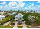 Two story home with a detached garage, landscaped yard, and driveway at 727 Holly Rd, Anna Maria, FL 34216
