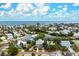 Aerial view of a two-story house with a pool, located in a residential neighborhood near the ocean at 727 Holly Rd, Anna Maria, FL 34216