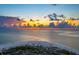 Aerial view of beach at sunset, showing calm ocean and clouds at 727 Holly Rd, Anna Maria, FL 34216