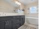 Modern bathroom with double vanity and soaking tub at 727 Holly Rd, Anna Maria, FL 34216